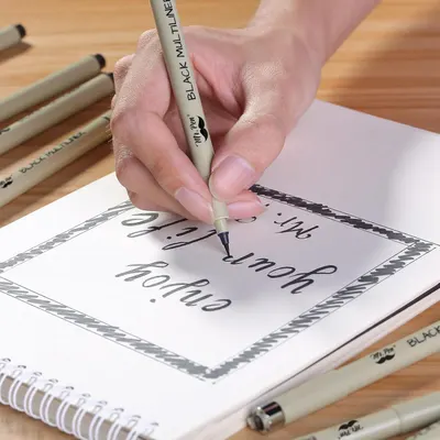 Demonstrates the product being used in a real-world creative context to show shoppers how the pen performs for hand lettering and calligraphy work.