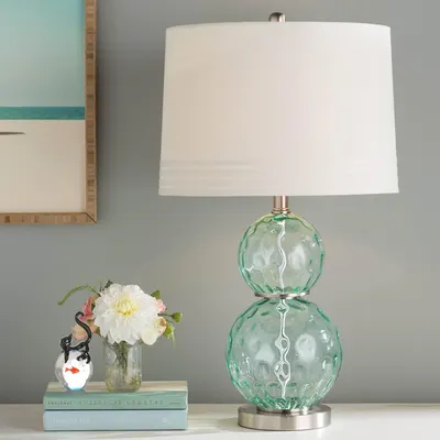 Showcases the lamp in a styled home environment to help shoppers visualize how the product looks in a real-world setting and fits with their decor.