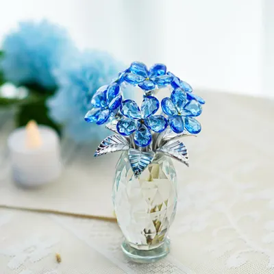 Showcases the product in a real-world home setting to help shoppers visualize how the decorative crystal flower piece would look displayed in their own space.
