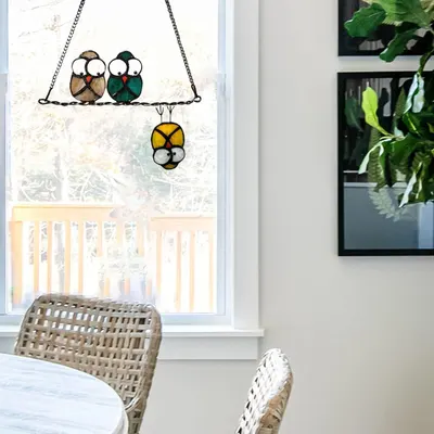 Demonstrates the product as a decorative window hanging in a real home setting to help shoppers visualize how it looks in use.