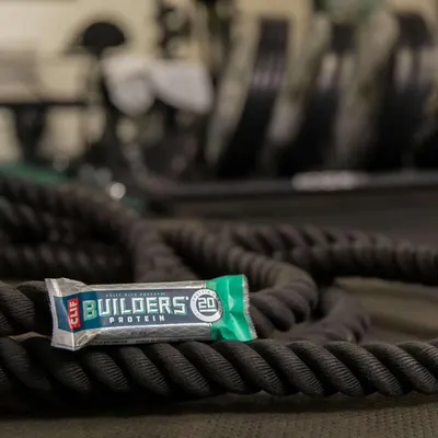 Positions the protein bar as part of an active fitness lifestyle by showing it in a gym setting with workout equipment, appealing to fitness-conscious consumers.