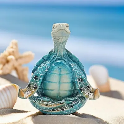 Showcases the decorative turtle figurine in a natural beach environment to evoke a coastal, relaxed aesthetic and help shoppers visualize it as home decor.