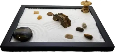 Shows the complete desktop zen garden set with all included decorative elements (stones, bridge, pagoda, rake) to give shoppers a clear view of what they receive.