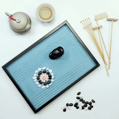 Shows all the items included in the zen garden kit to help shoppers understand the complete set they will receive, including the sand tray, stones, rakes, teapot, and decorative elements.