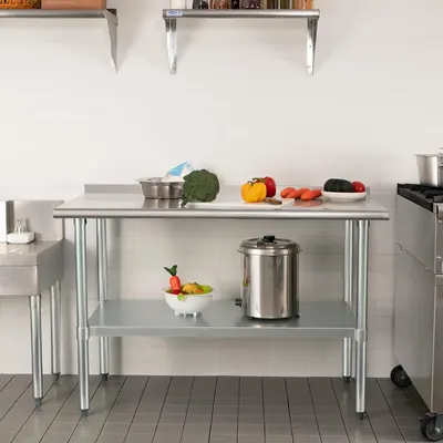 Demonstrates the product in a real-world kitchen setting to help shoppers visualize how the stainless steel work table fits into their cooking space and workflow.