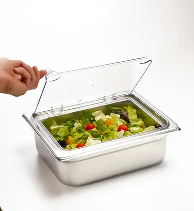 Demonstrates the product in a real-world kitchen setting, showing how the container holds fresh salad with its clear hinged lid, helping shoppers visualize practical everyday use.