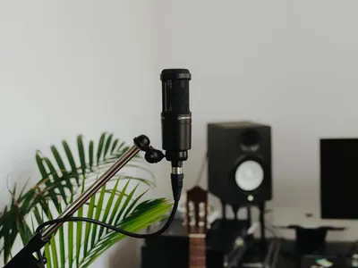Showcases the microphone in a real-world recording studio setting to help shoppers visualize the product in use and understand its professional audio application.