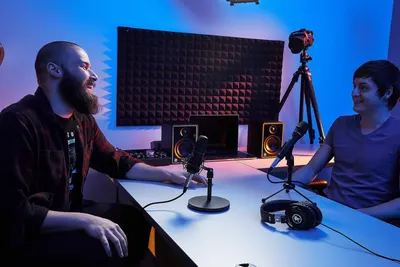 Demonstrates the product in a real-world podcasting or content creation environment to help shoppers visualize how they would use it in their own setup.