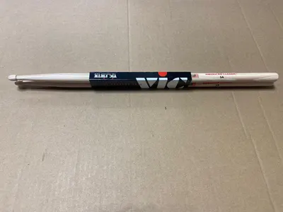 Shows the product in its retail packaging to help shoppers understand what they will receive when purchasing, including the pair of drumsticks and brand packaging.