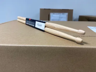 Shows the drumsticks with their retail packaging in a clean, catalog-style presentation to give shoppers a clear view of the product as it will arrive.