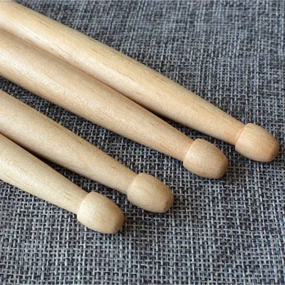 Displays the wooden drumsticks in a clean, catalog-style format to show the product clearly without distractions.