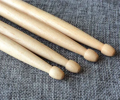 Provides a clean, catalog-style view of the wooden drumsticks on a neutral background to show the product clearly without distractions.