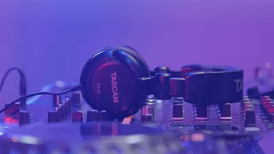 Showcases the headphones in a real-world professional audio/music production environment to help shoppers visualize the product in use and establish credibility for studio or DJ applications.