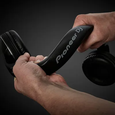 Demonstrates the product being used in a real-world DJ/audio professional context to help shoppers visualize how they would use the headphones.