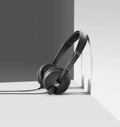 Showcases the headphones in an artistic, minimalist studio setting to convey premium quality and modern design aesthetics.