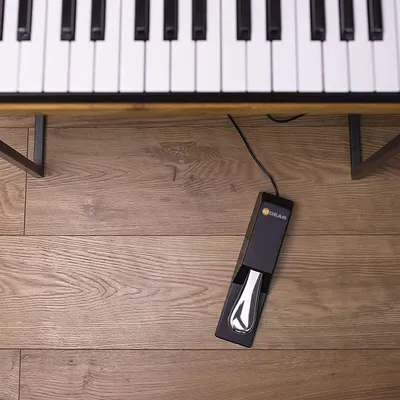 Demonstrates the product in its real-world context beneath a piano, showing shoppers how it naturally integrates into their musical setup.