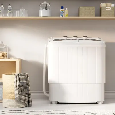 Shows the portable washing machine in a realistic home environment to help shoppers visualize how it fits into their living space and daily routine.