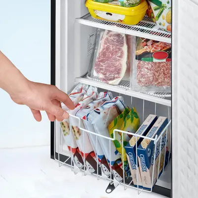 Demonstrates the convenient pull-out basket feature that helps organize frozen foods and makes items easily accessible in the freezer.