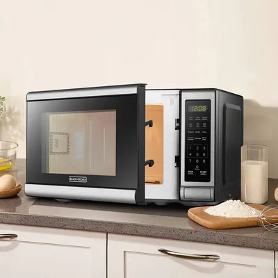 Shows the microwave in a real kitchen setting to help shoppers visualize how the product looks and fits in their home environment.
