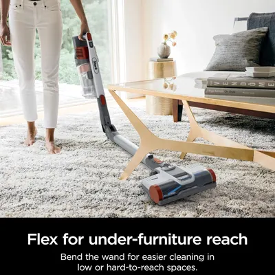 Demonstrates the vacuum's flexible wand feature that allows users to easily clean under furniture and hard-to-reach spaces, solving a common cleaning pain point.