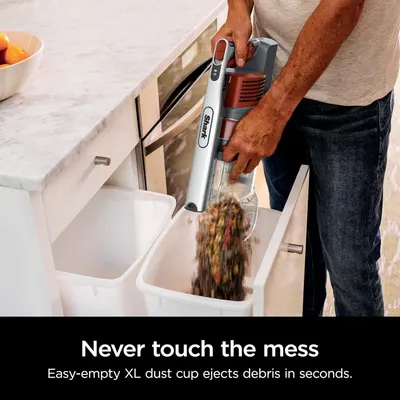 Demonstrates the convenience and hygiene of the XL dust cup's one-touch ejection system, reassuring shoppers they can dispose of debris quickly without touching the mess.