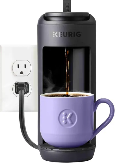 Demonstrates the coffee maker's compact footprint by showing it plugged into a standard wall outlet, reassuring shoppers it won't take up much counter space.