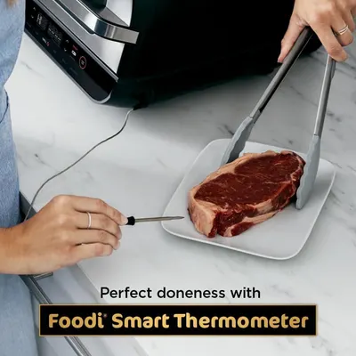 Demonstrates the product's ability to achieve perfect cooking results by using a smart thermometer to monitor meat doneness, reassuring shoppers of precision and cooking confidence.