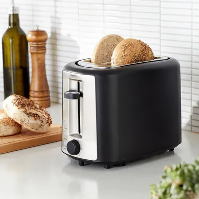 Shows the toaster in a real-world kitchen setting with bagels being toasted, helping shoppers visualize the product in their own home and understand its everyday use.