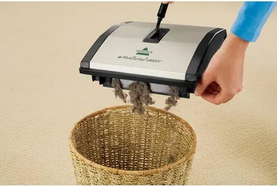 Demonstrates the product's ability to effectively pick up and collect dirt, dust, and debris from carpets, reassuring shoppers of its cleaning performance.