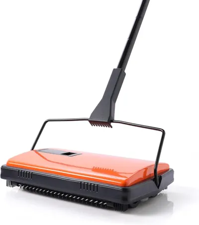 Provides a clean, catalog-style view of the manual carpet sweeper product to show its design and structure without distractions.
