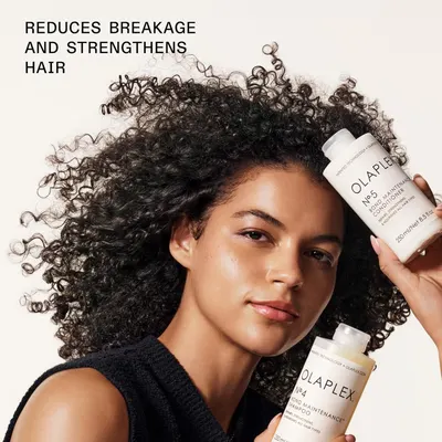 Communicates the primary benefit of the hair care products—reducing breakage and strengthening hair—through a clean lifestyle photo with a single headline and product display.