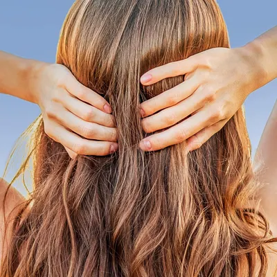 Demonstrates the product in use within a real-world context, showing someone applying or caring for their hair to help shoppers visualize the product's application and results.