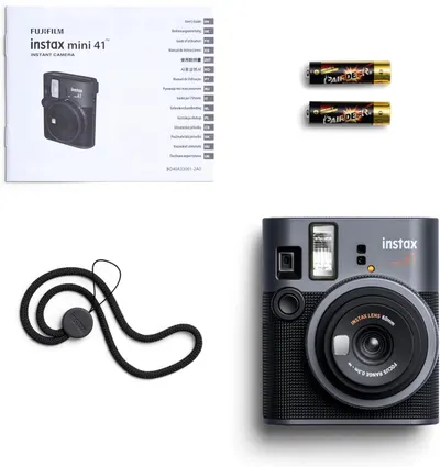 Shows the customer everything included in the box: the Instax Mini 41 camera, instruction manual, batteries, and carrying strap, providing clarity on what they will receive with their purchase.