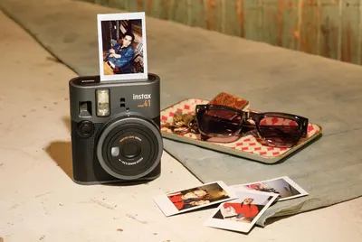 Showcases the product in a natural, aspirational lifestyle setting to help shoppers visualize how the instant camera fits into everyday moments and personal style.