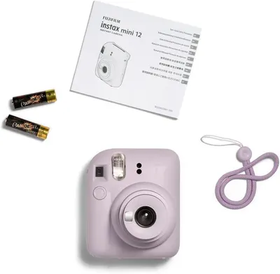 Shows everything included in the package: the Instax Mini 12 camera, instruction manual, batteries, and carrying strap, reassuring shoppers they receive a complete ready-to-use kit.
