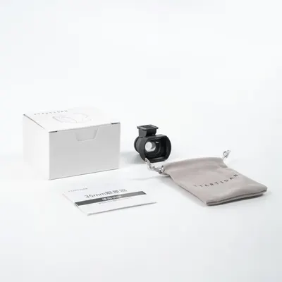Shows everything included in the purchase: the viewfinder accessory, protective pouch, instruction manual, and retail packaging to reassure shoppers they are getting a complete kit.