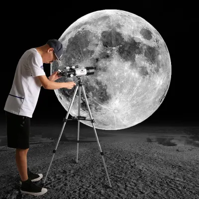 Demonstrates the telescope in a real-world astronomy context, showing a person using it to observe the moon, helping shoppers visualize themselves using the product for stargazing.