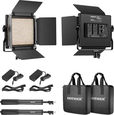 Shows everything included in the purchase: two LED light panels with barn doors, power adapters, cables, light stands, and carrying cases to demonstrate the complete value of the bundle.