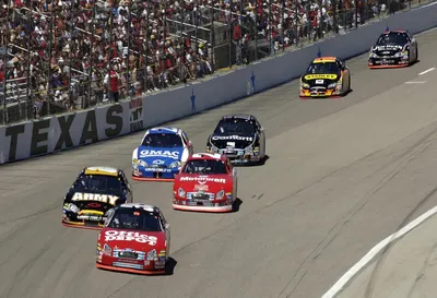 Demonstrates the product in a real-world racing environment to create excitement and show authentic usage context.