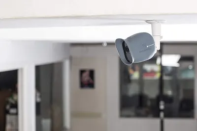 Demonstrates the product in a real-world home environment to show shoppers how the security camera integrates naturally into their living space for home monitoring.