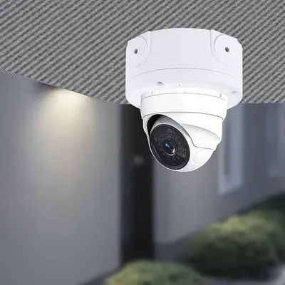 Shows the security camera installed in a real-world setting to help shoppers visualize how the product looks when mounted and in use.