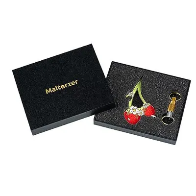 Shows the customer everything included in the purchase: the decorative cherry brooch and keychain accessories, presented in premium branded packaging.