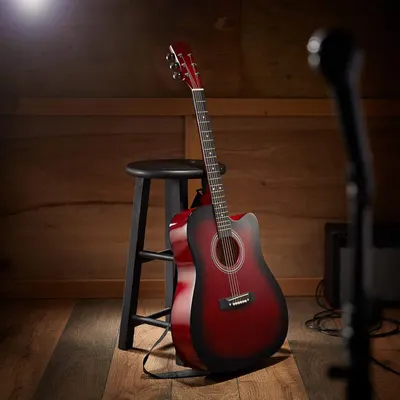 Showcases the guitar in an authentic lifestyle environment to help shoppers visualize the product in a real-world music or home setting.