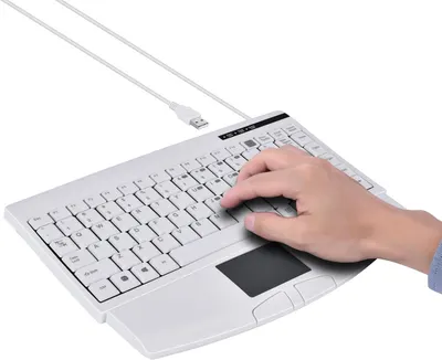 Shows the product being used in a real-world context with a hand interacting with the keyboard and touchpad, demonstrating its practical functionality and ergonomic design.
