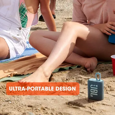 Demonstrates the product in a real-world beach setting to show its portability and suitability for outdoor leisure activities. Highlights the compact, portable nature of the speaker with a clear…