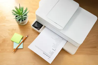 Demonstrates the product in a real-world home or office setting to help shoppers visualize how the printer fits naturally into their workspace.