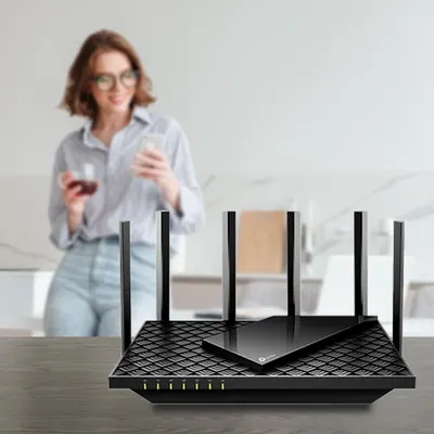 Demonstrates the product in a real-world home environment to help shoppers visualize the router in their own living space and understand its unobtrusive design.