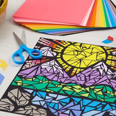 Shows shoppers everything included in the craft kit—colorful paper sheets, scissors, and a geometric art template—to demonstrate the complete value and creative possibilities of the purchase.