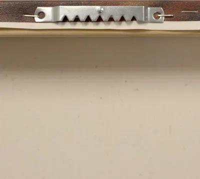 Demonstrates the sawtooth hanger mechanism on the back of the frame, showing shoppers how the product is designed for easy wall mounting.
