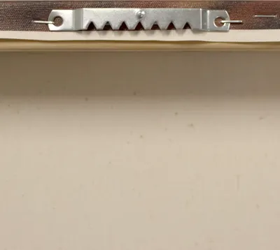 Shows the physical mounting hardware component of the product to demonstrate how it hangs securely on walls.